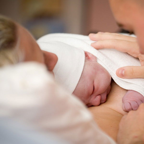 Parent holding a newborn child who has suffered a birth injury
